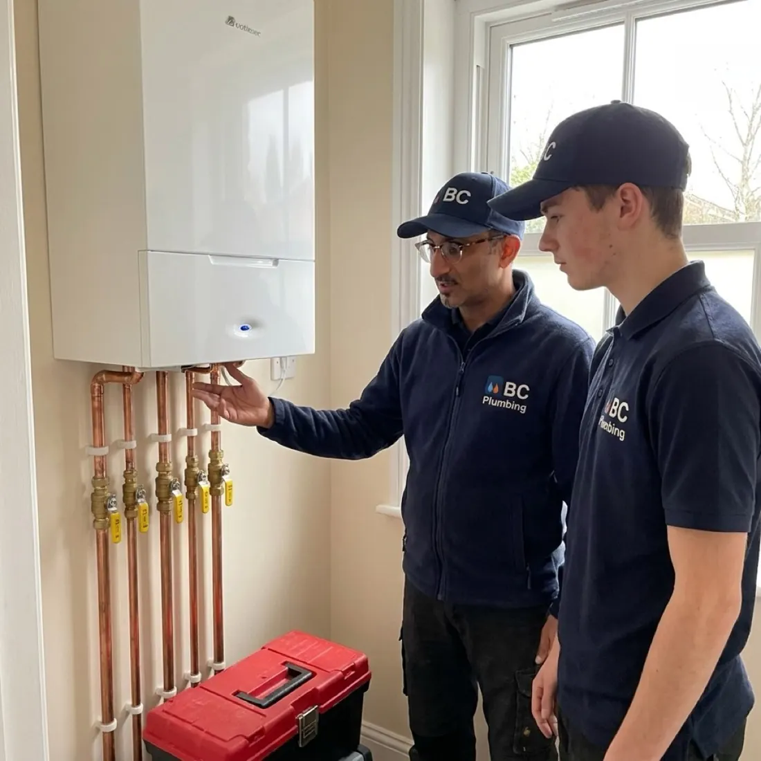 VJ from BC Plumbing diagnosing a wall-mounted combi boiler with his apprentice in a Wolverhampton home